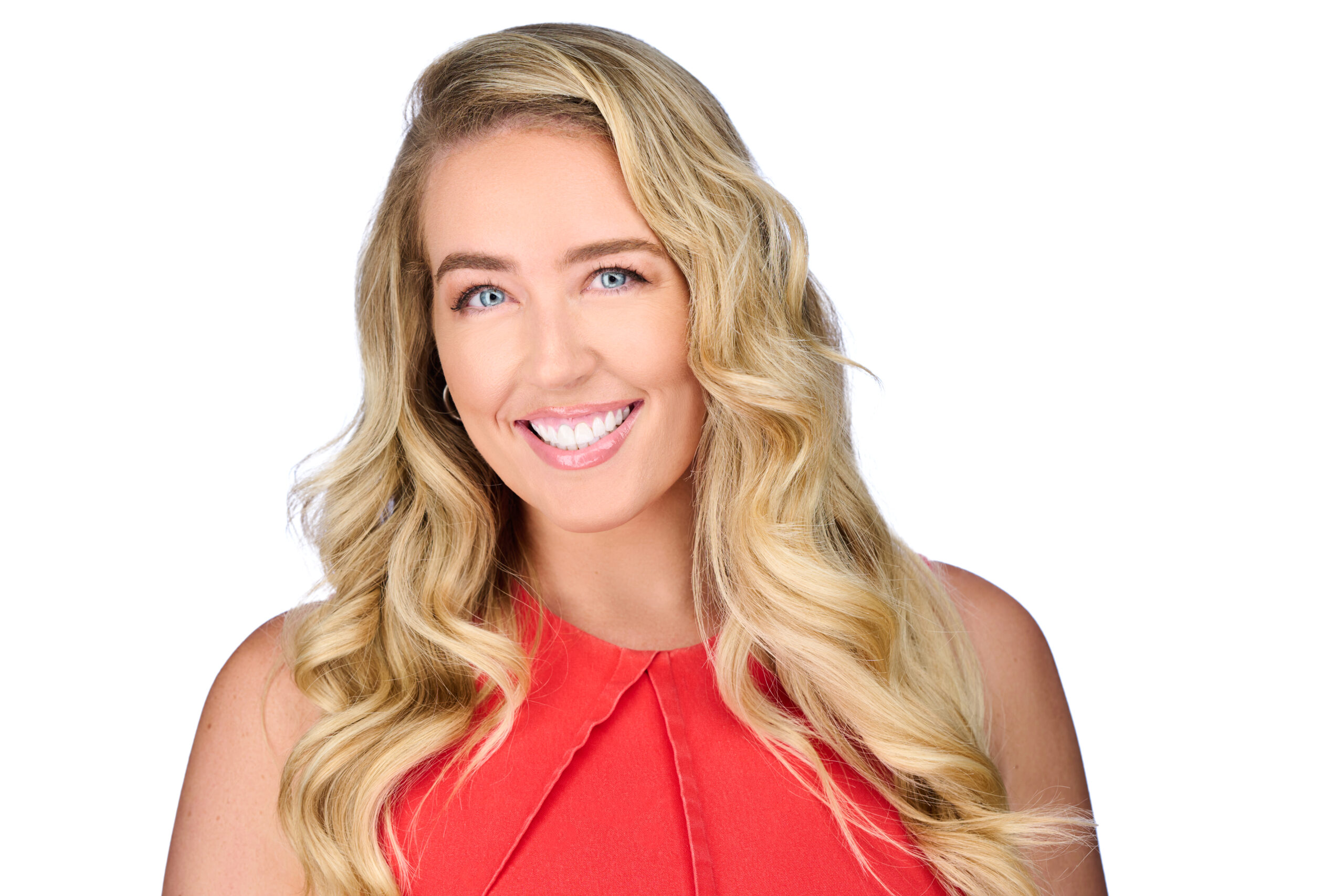Shannon smiles at the camera in a bright red blouse.
