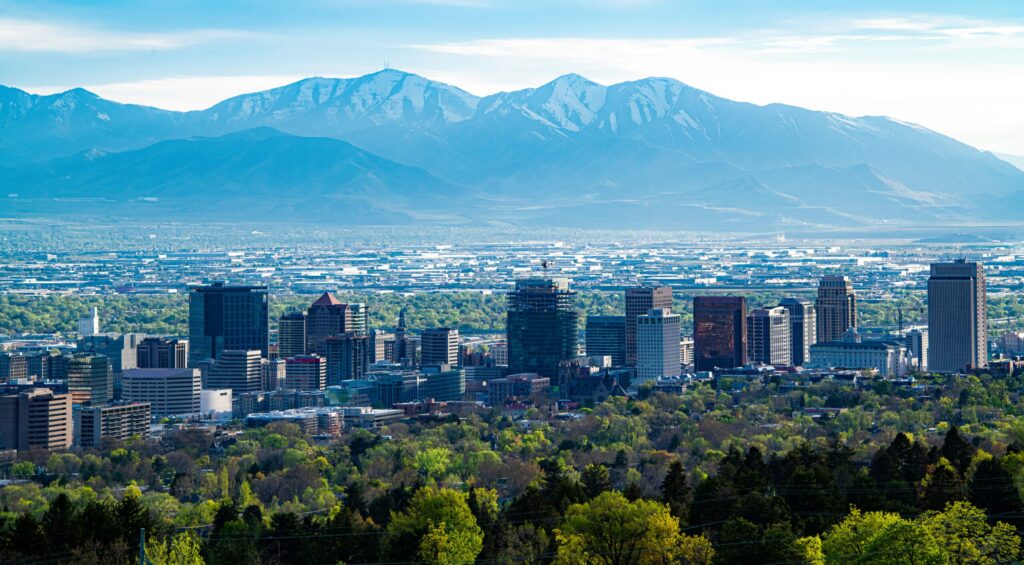 A city skyline across green mountain during daytime.